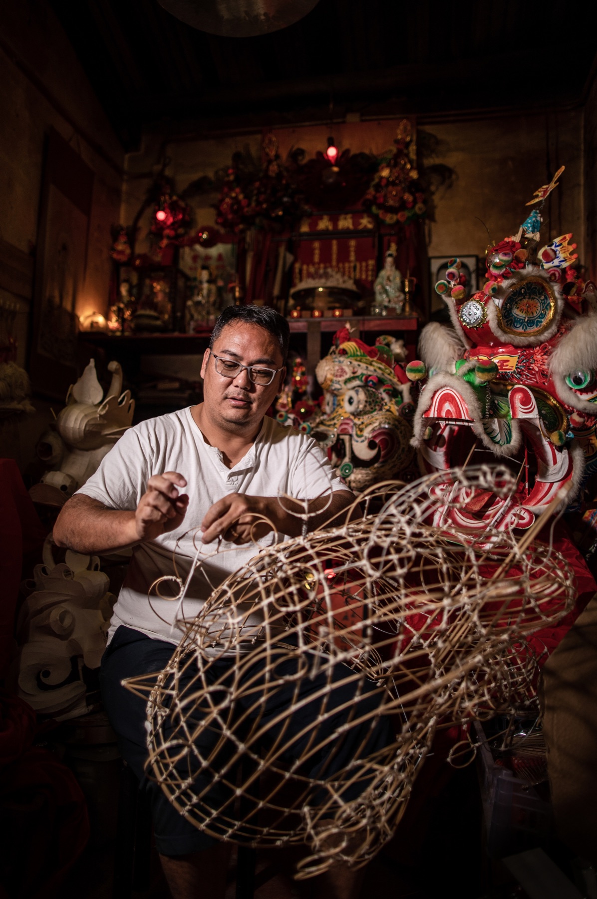 Craftsperson weaving the bamboo frame of a traditional qilin figure