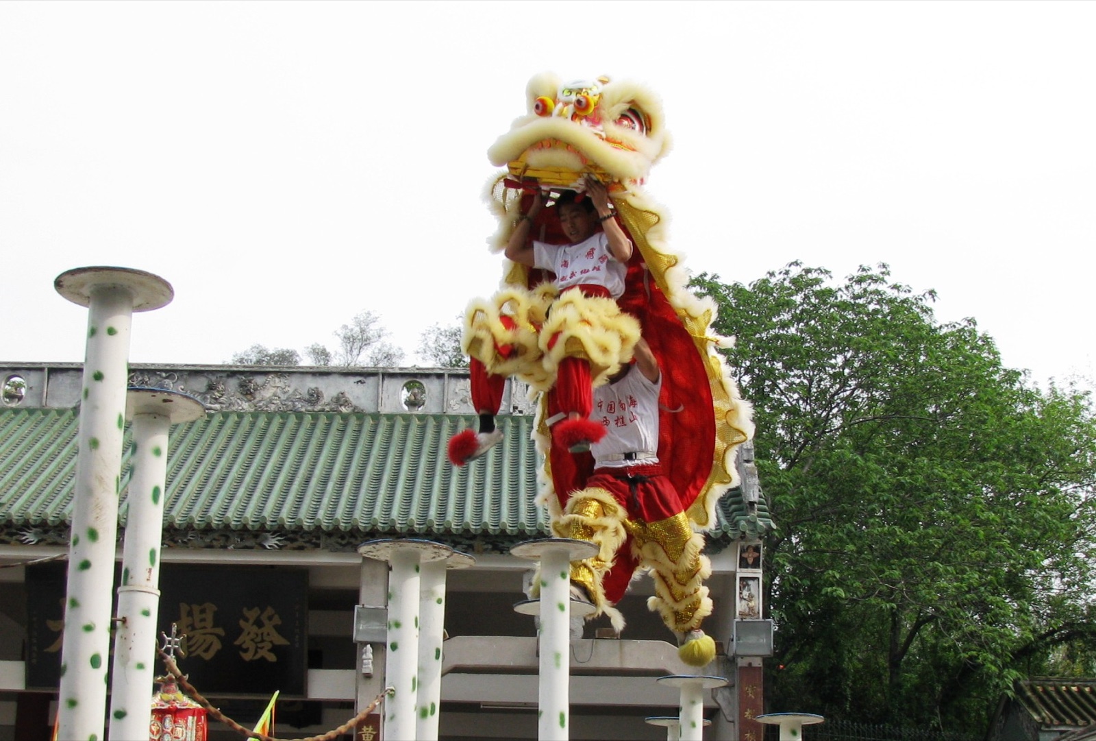 A lion-dance team performs on raised poles in Foshan, China.