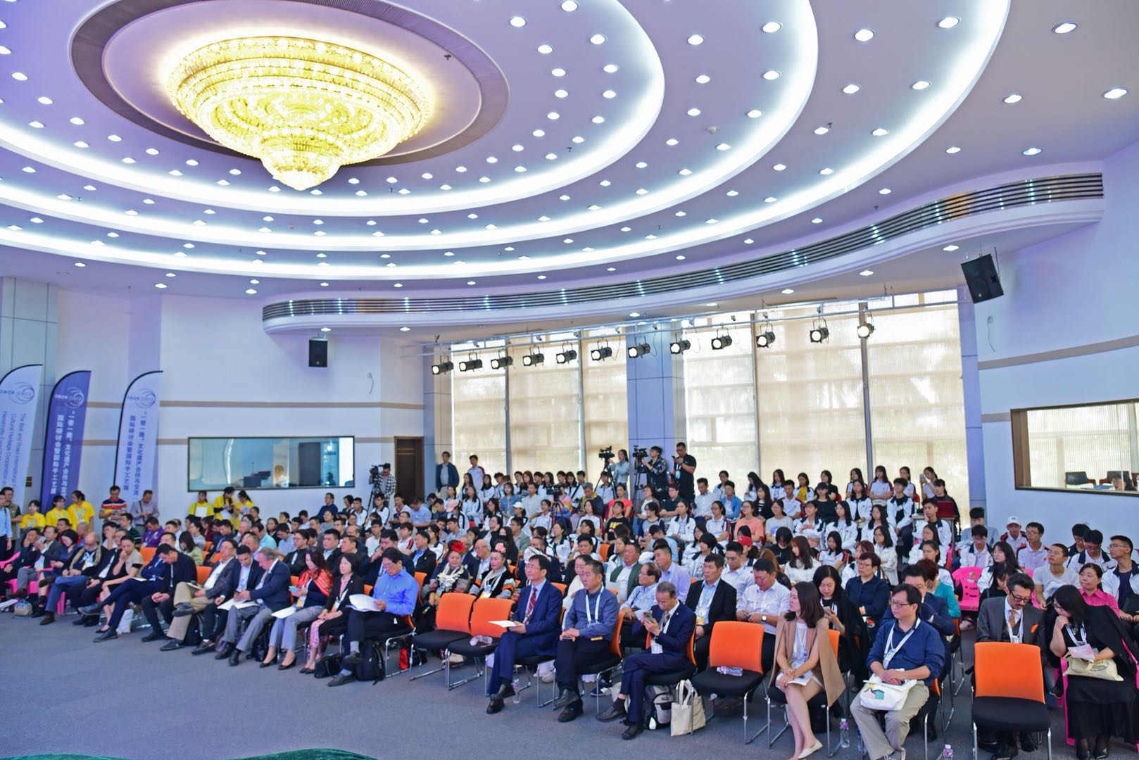 A large audience of delegates seated in a conference hall